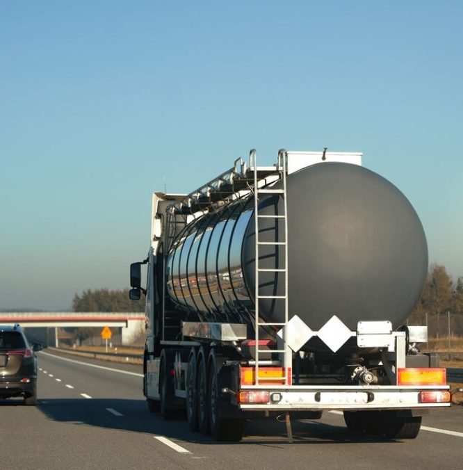 [freepicdownloader.com]-chrome-cistern-carrying-oil-gas-glides-through-city-s-veins-commerce-large